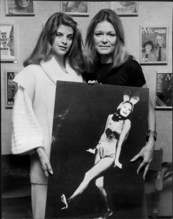 Kirstie Alley posing with Gloria Steinem holding a poster of Gloria for the PlayBoy cover